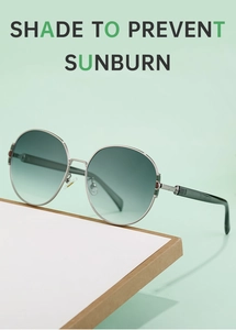 Detail of round oversized sunglasses with gradient lenses and slim metal frames