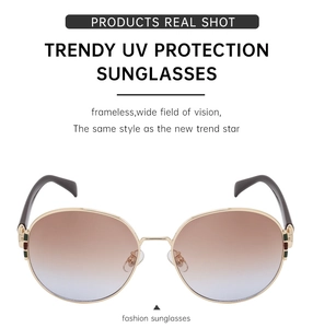 Detail of rimless gradient sunglasses with gold bridge and signature stripe on temples