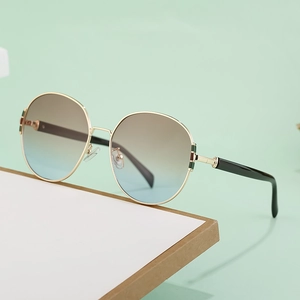 Chic oversized round sunglasses with gold metal frame and gradient brown to blue lenses