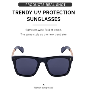 Detail of trendy black square sunglasses with metallic gold hinges and UV protection lenses