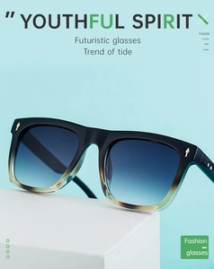 Detail of gradient tea frame sunglasses with iconic gold arrow rivets on blue background