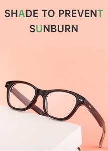 Side view of black cat-eye sunglasses with silver star rivets on a white cube