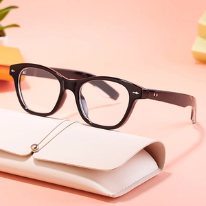 Retro black full-rim cat eye glasses with silver rivets and cream leather pouch