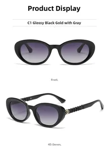 Detail view of cat eye sunglasses with gold flower logo on glossy black temples