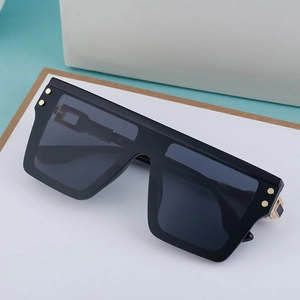 Polarized square sunglasses for men with black frame and gold rivet accents on white surface
