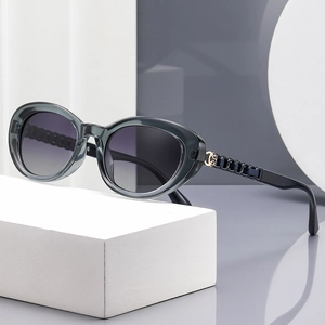 Polarized oval sunglasses in transparent grey frame with luxury chain metal temples