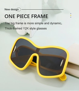 Detail of trendy yellow Y2K oversized sunglasses with one-piece frame and metal accents