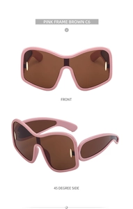 Detailed front and side view of pink oversized sunglasses with gold metal oval accents