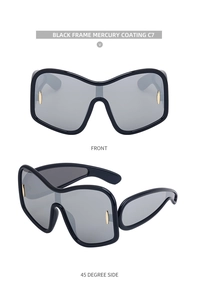 Macro detail of black oversized sunglasses with silver mercury lenses and gold accents