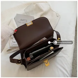 Detail view of the multi-compartment interior for dark brown retro square crossbody bag