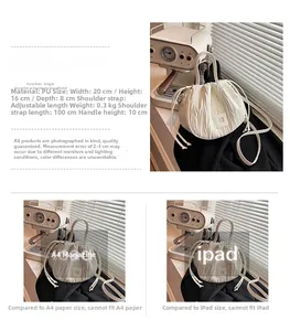 Size comparison of white pleated bucket bag with iPad and A4 magazine for scale