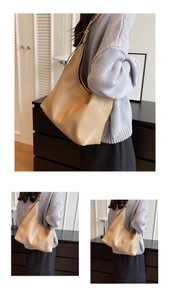 Close-up of a large beige bucket bag with lychee texture and slouchy design