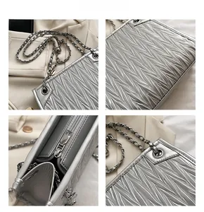 Detail of silver matelassé quilted chain bag showing the metallic texture and stitching