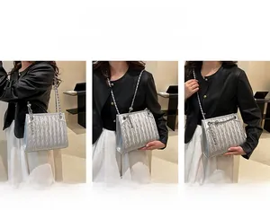 Detail of silver pleated quilted chain bag showing single shoulder and crossbody styling