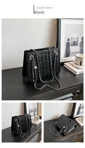 Detailed views of a black quilted chain bag featuring elegant V-shaped crinkle textures