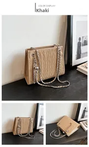 Detail of khaki quilted tote bag with herringbone stitching and silver chain strap
