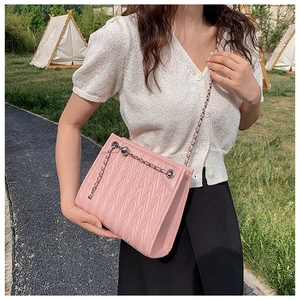 Pink matelassé quilted chain bag with silver bead detail and woven leather strap