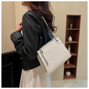 White pleated leather shoulder bag with silver chain strap and fringe tassel detail