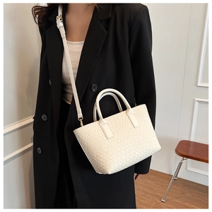 Close-up of white woven texture and fine craftsmanship on the PU leather tote bag