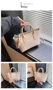 Detail shot of beige woven leather texture and gold buckle on a chic tote bag
