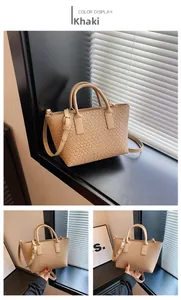 Detail of khaki woven texture tote bag with detachable strap and top handle