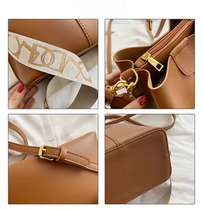 Détails du sac seau en cuir marron montrant les coutures fines et les ferrures dorées