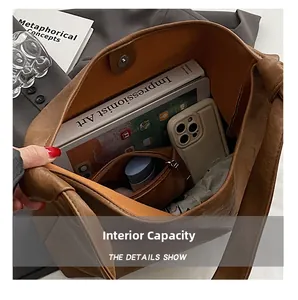 Spacious interior of brown tote bag showing capacity for tablet, phone, and essentials