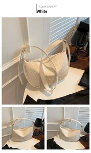 Detail of white pleated hobo bag with V-shaped quilted texture and adjustable strap