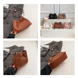 Detailed views of pleated chain bucket bag in multiple colors with quilted texture