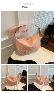 Detail shot of the pink pleated dumpling bag featuring wavy textures and adjustable strap