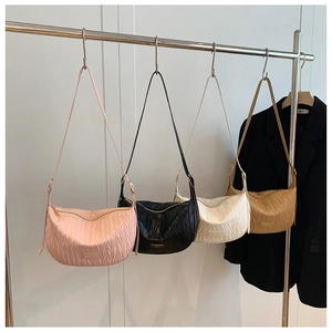 Vertical pleated hobo bags in four colors hanging on a metal rack for detailed display