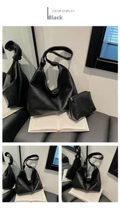 Detail of black pebbled leather tote set featuring a unique knotted shoulder strap