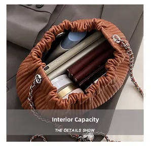Interior view showing capacity for smartphone, wallet, and lipstick in the brown bucket bag
