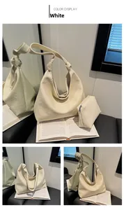Detail of cream hobo bag with pebble leather texture and knot shoulder strap design