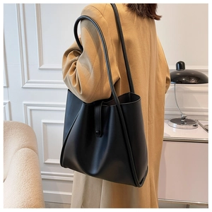 Minimalist black matte leather tote bag shown on model for daily commuting style