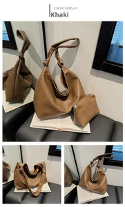 Detail of khaki soft leather bucket bag with matching pouch and knotted shoulder strap