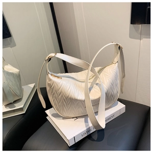 Detailed close-up of white pleated PU leather shoulder bag with gold metal zipper accents