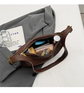 Interior view of the dark brown leather shoulder bag showing large storage capacity