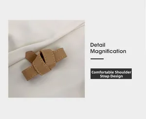 Dettaglio della tracolla in pelle caramello con cuciture raffinate e design a nodo morbido