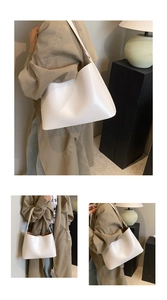 Minimalist white leather tote bag with brown lining and long shoulder strap in daily use
