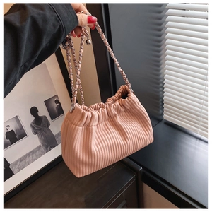 Close-up of pink pleated bucket bag with silver metal and leather chain strap