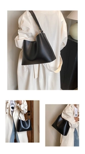 Detailed views of a minimalist black leather hobo bag with a wide shoulder strap