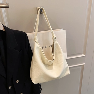 Minimalist cream white hobo bag with knotted leather strap and soft vintage texture