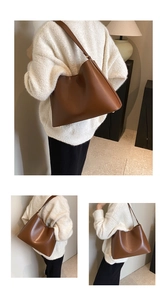Detail view of brown matte leather tote bag featuring metal bottom studs and wide strap