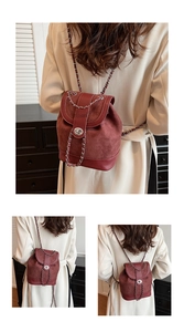 Detail of burgundy leather mini backpack with metal chain and turn-lock closure