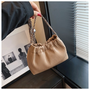 Detailed view of the pleated oatmeal bucket bag with a silver chain and metal bead
