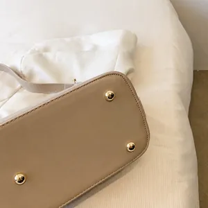 Close-up of base with four golden metal feet for wear resistance and clean stitching