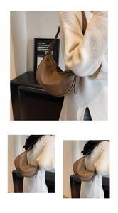 Detail view of brown vintage textured half-moon hobo bag with natural faux leather folds