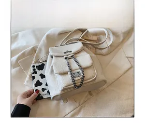 Detail of off-white textured leather backpack with silver chain and twist lock closure