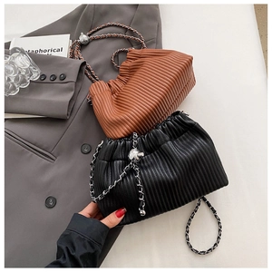 Detail of pleated texture and leather chain strap on brown and black bucket bags